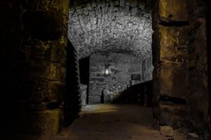 City of the Dead Underground Vaults (Day) - The story engine: ghost tales tied to real suffering